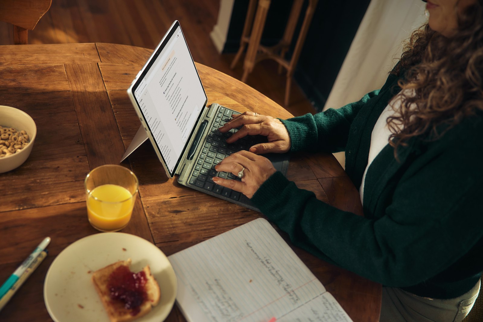 Member signing in to Patelco online banking on a laptop at a kitchen table