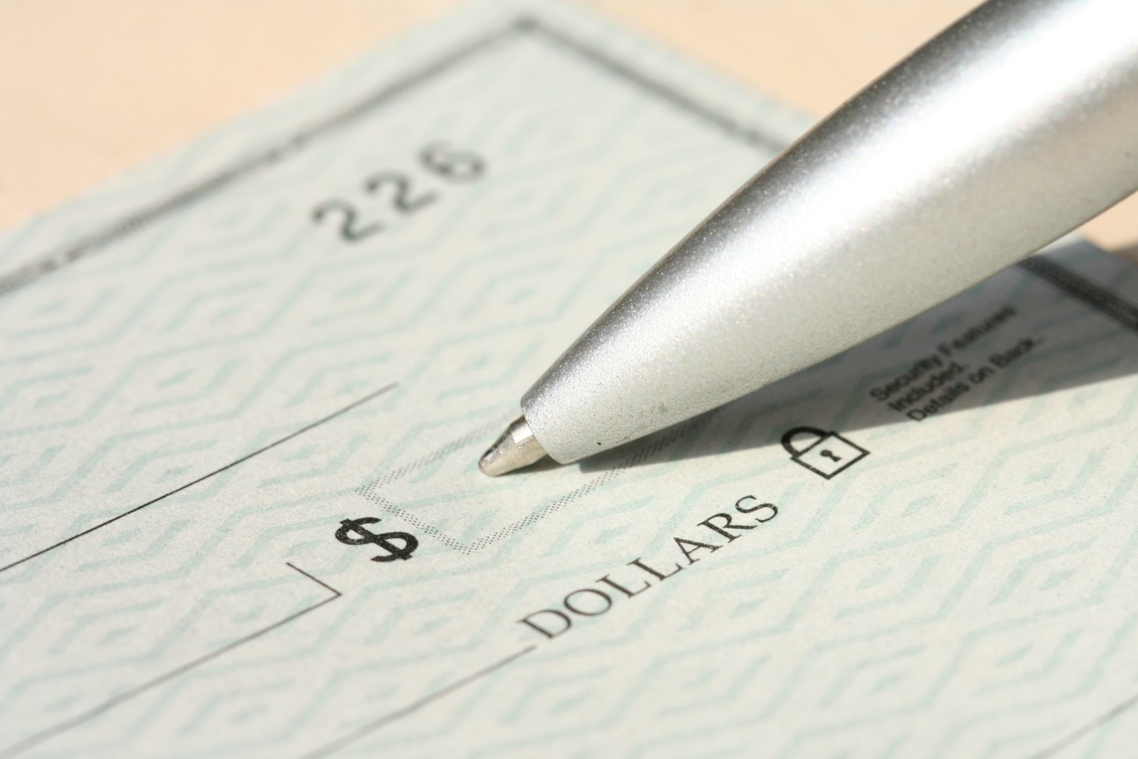 A paper check showing where the nine-digit routing number and account number appear along the bottom edge